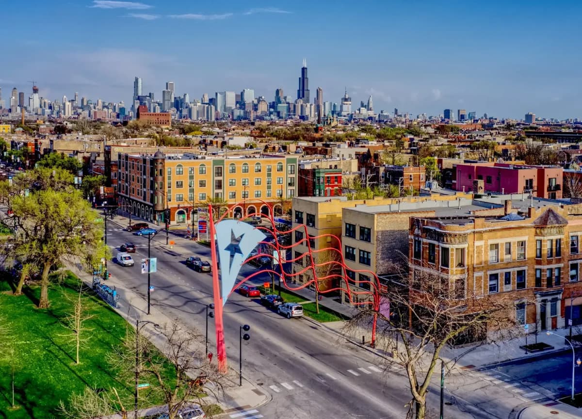 Chicago Humboldt Park neighborhood street of two-flats with the downtown skyline beyond
